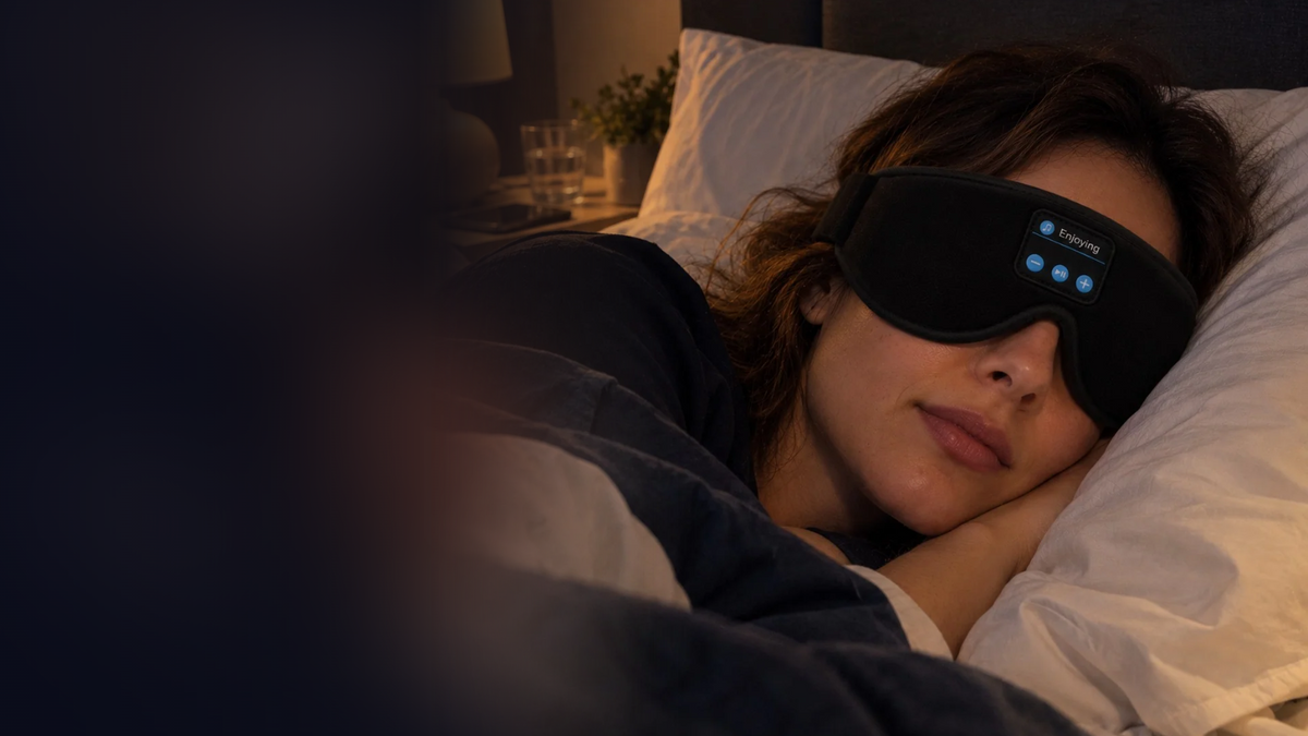 Woman asleep in pyjamas wearing the Lullwave 3D Bluetooth sleep mask